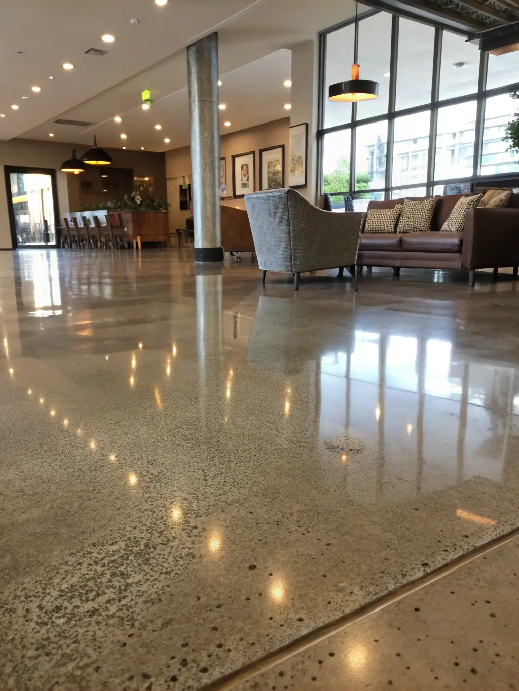 A close-up of a residential living room floor with a flawless, glossy epoxy finish, reflecting natural light and modern decor.